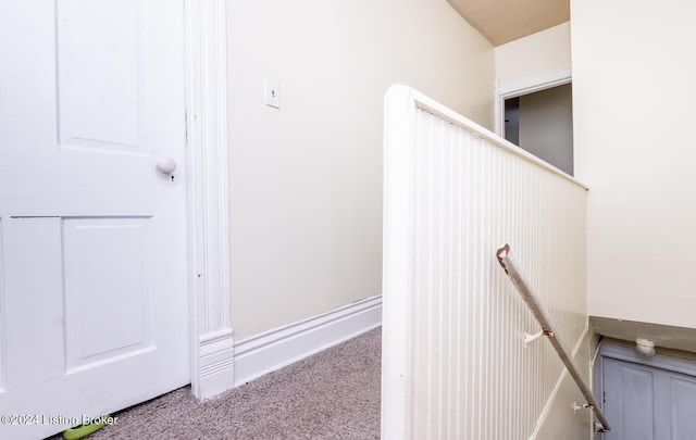 stairs featuring carpet