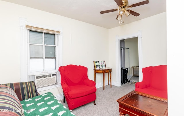 sitting room with ceiling fan, cooling unit, and light carpet