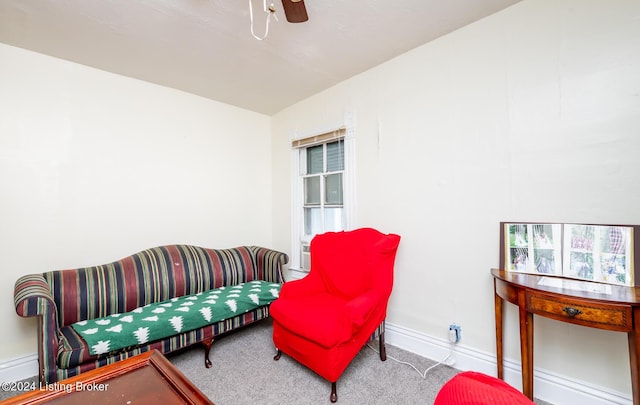 interior space with carpet flooring and ceiling fan