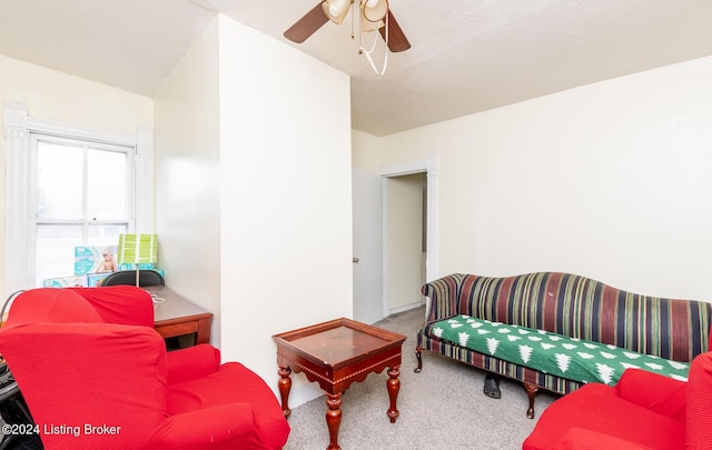 living room featuring carpet floors and ceiling fan