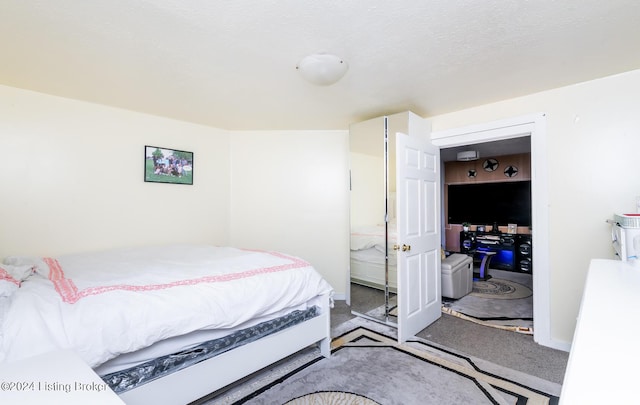 carpeted bedroom with a textured ceiling