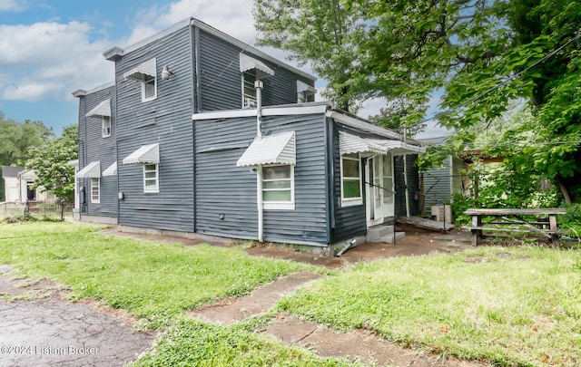 view of property exterior featuring a lawn