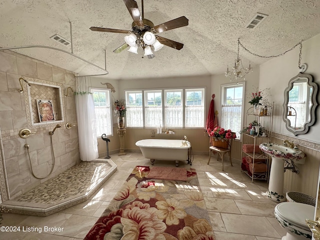 bathroom featuring tile flooring, a textured ceiling, separate shower and tub, ceiling fan, and toilet