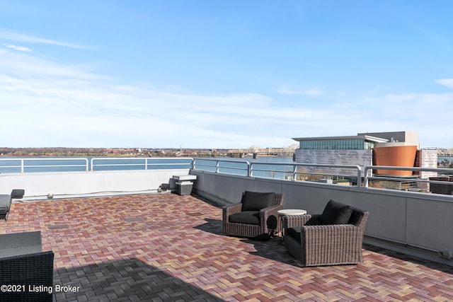 view of patio / terrace featuring a water view and a balcony