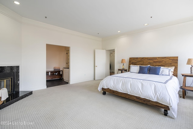 bedroom featuring carpet flooring, a fireplace, and ornamental molding