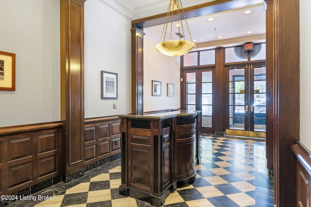 kitchen with french doors, dark tile flooring, and hanging light fixtures