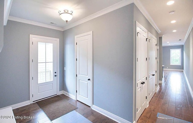 entrance foyer featuring dark wood-type flooring and ornamental molding