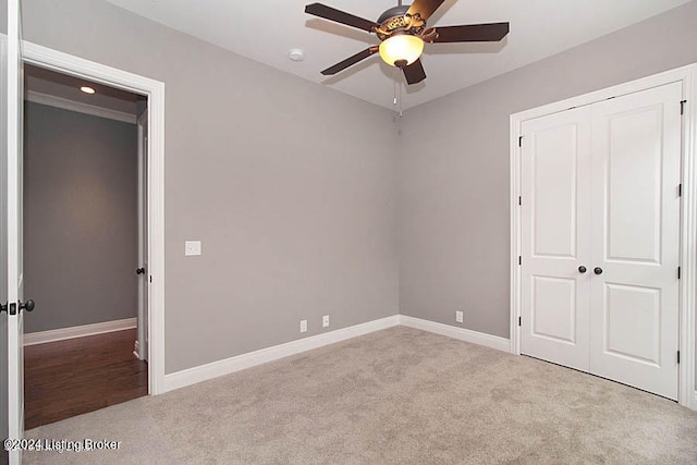 unfurnished bedroom with hardwood / wood-style floors, a closet, and ceiling fan