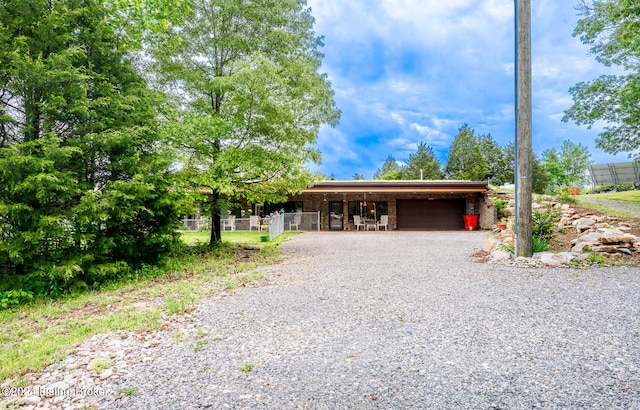 view of front of house featuring a garage and a carport