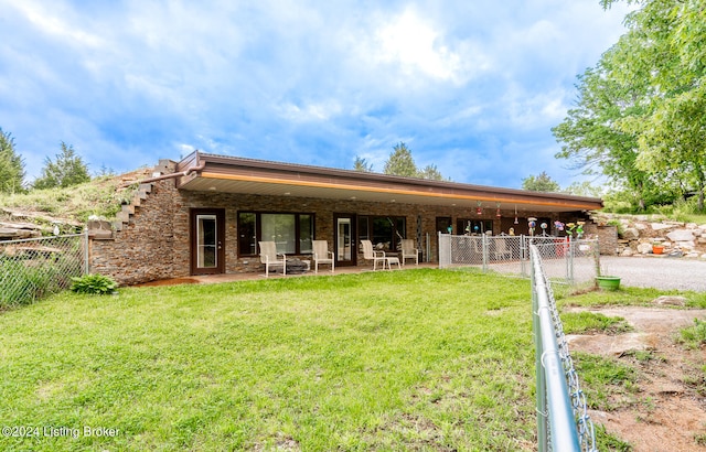 view of front of house featuring a front lawn and a patio