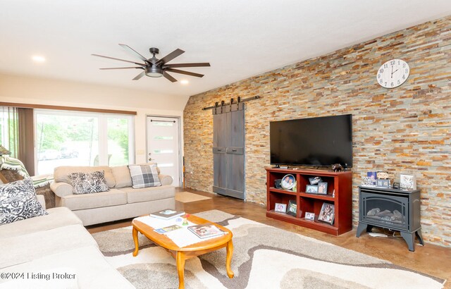 living room with ceiling fan and a wood stove