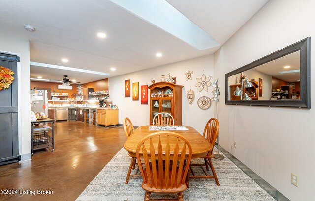 dining area with concrete floors and ceiling fan