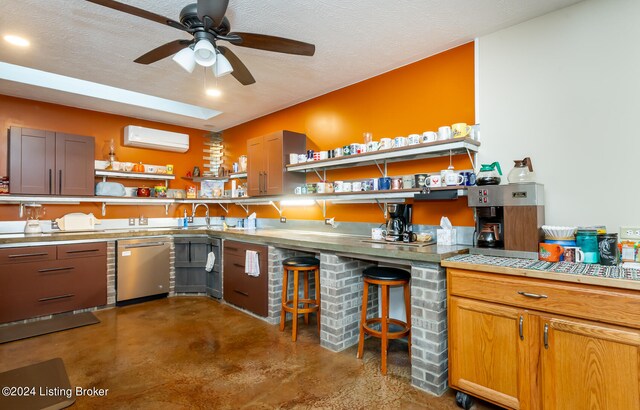 kitchen featuring ceiling fan, concrete flooring, dishwasher, a wall mounted air conditioner, and a textured ceiling