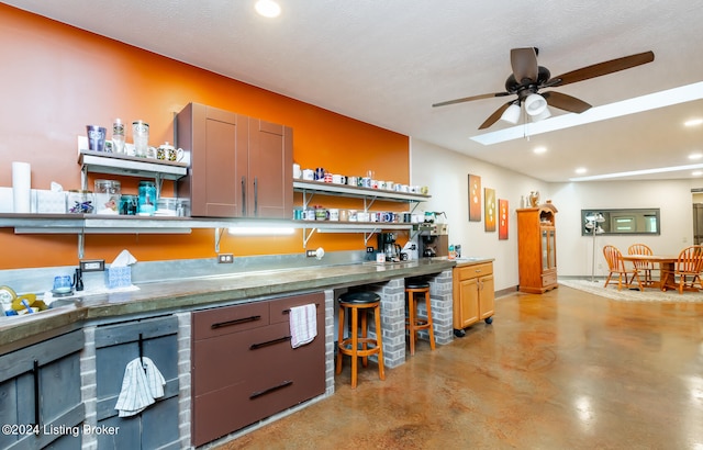 kitchen featuring a textured ceiling and ceiling fan