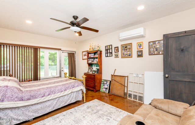 bedroom featuring a wall unit AC, ceiling fan, and a textured ceiling