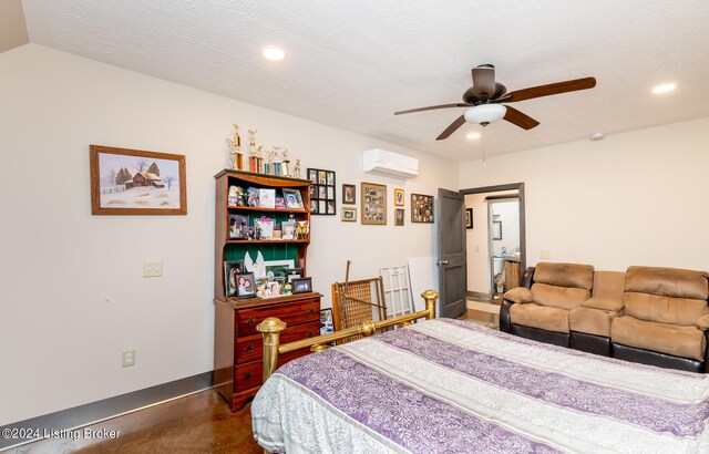 bedroom featuring a wall mounted air conditioner, ceiling fan, a textured ceiling, and concrete flooring