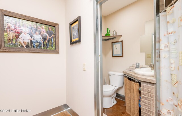 bathroom featuring tile flooring, large vanity, and toilet