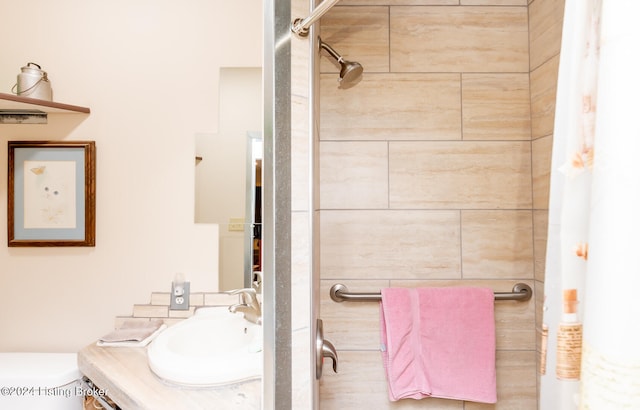 bathroom featuring a shower with shower curtain, toilet, and oversized vanity