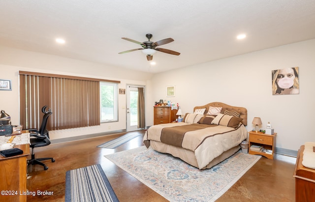 bedroom with ceiling fan, concrete floors, and a textured ceiling