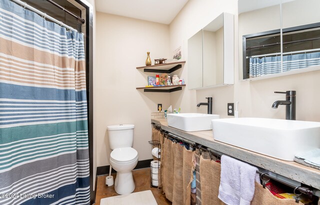 bathroom featuring hardwood / wood-style floors, oversized vanity, and toilet