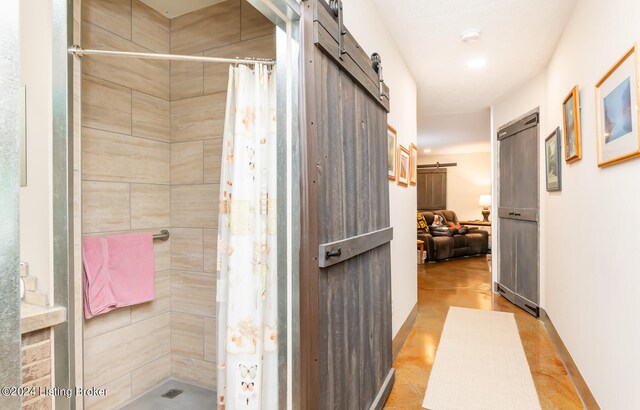 bathroom featuring tile flooring and curtained shower