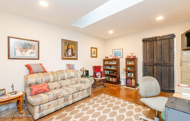 living room with light hardwood / wood-style flooring and a skylight