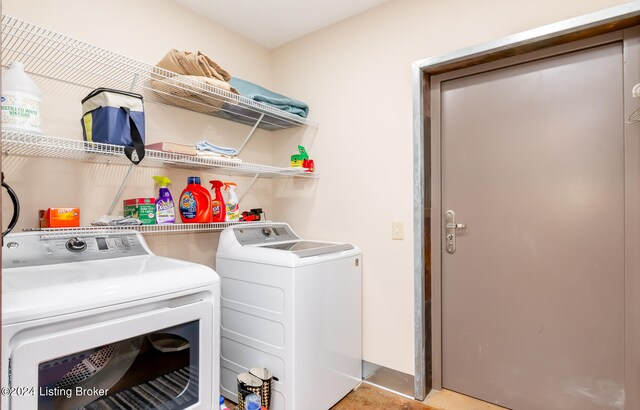 clothes washing area with washing machine and dryer