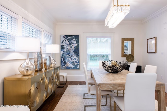 dining space with ornamental molding, a wealth of natural light, dark hardwood / wood-style floors, and an inviting chandelier