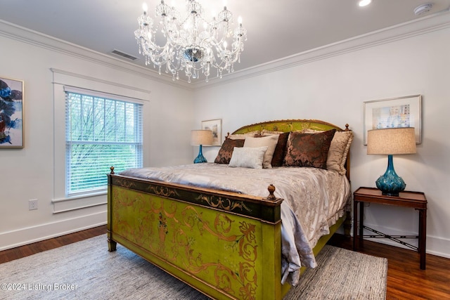 bedroom with hardwood / wood-style flooring, crown molding, and a notable chandelier