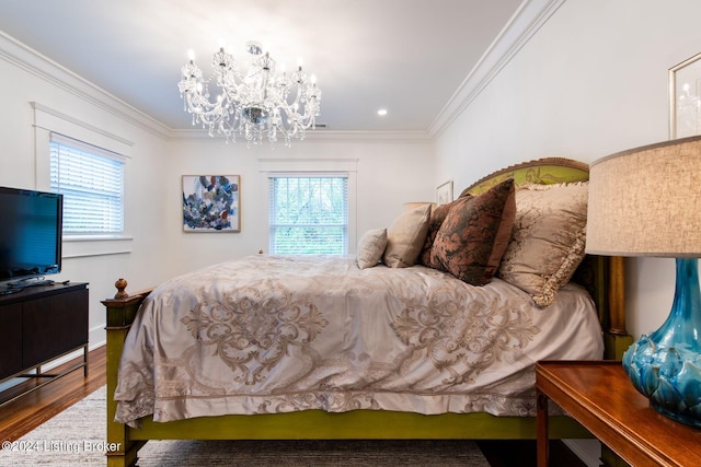 bedroom with hardwood / wood-style floors, multiple windows, and ornamental molding