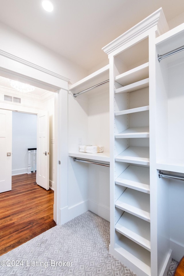 spacious closet featuring hardwood / wood-style floors