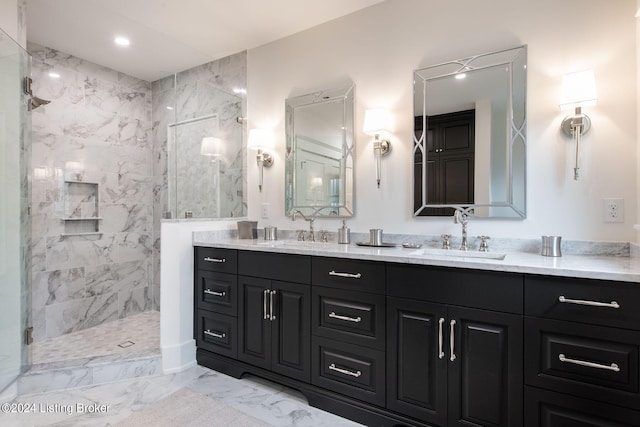 bathroom with vanity and tiled shower