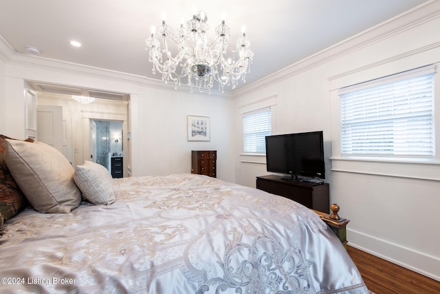 bedroom with wood-type flooring, ornamental molding, and a notable chandelier