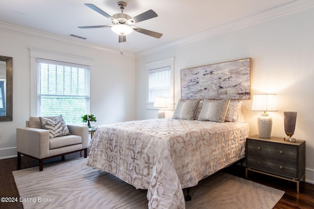 bedroom with ceiling fan, dark hardwood / wood-style floors, and ornamental molding