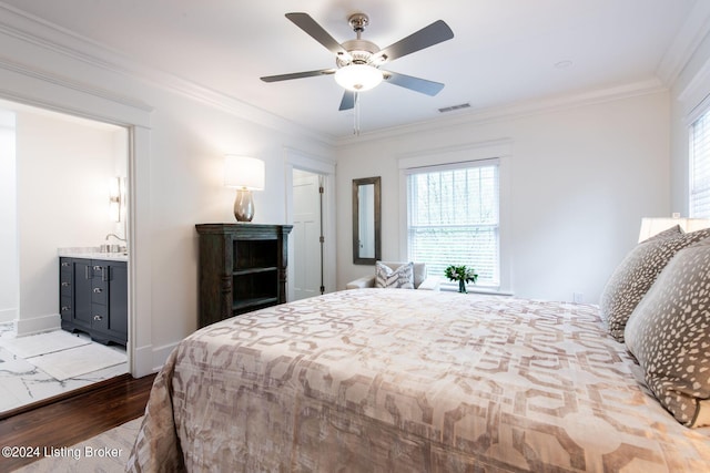 bedroom with ornamental molding, ensuite bath, sink, light hardwood / wood-style floors, and ceiling fan