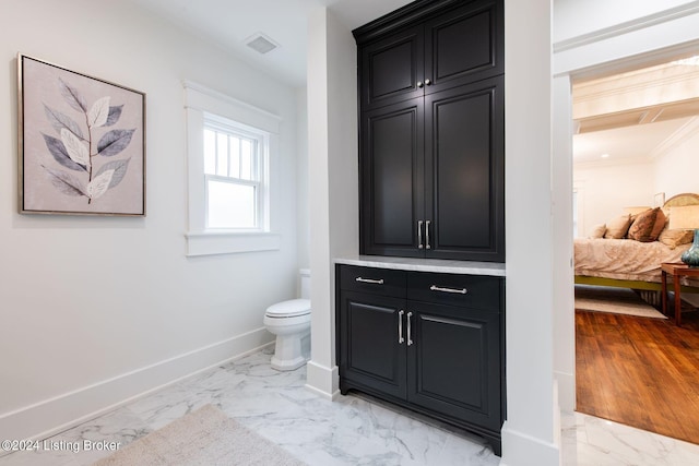 bathroom featuring hardwood / wood-style flooring and toilet