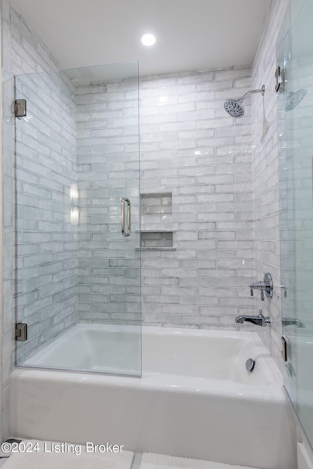 bathroom featuring bath / shower combo with glass door