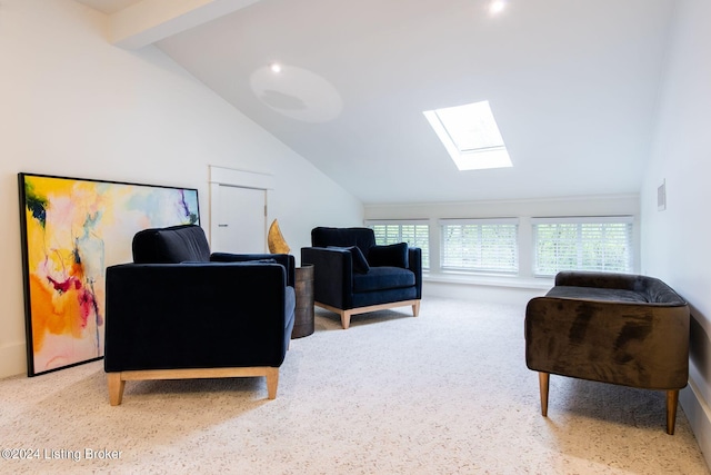 living area featuring lofted ceiling with skylight