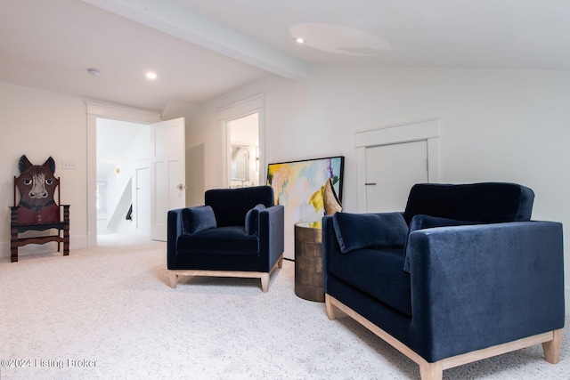 sitting room featuring vaulted ceiling with beams