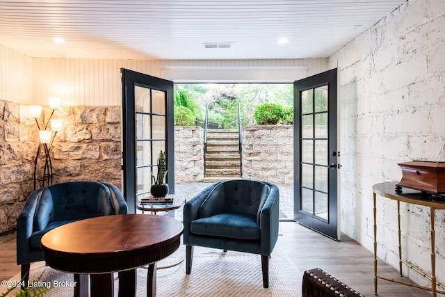 sitting room featuring french doors and light hardwood / wood-style floors