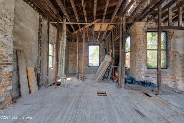 misc room with brick wall and plenty of natural light