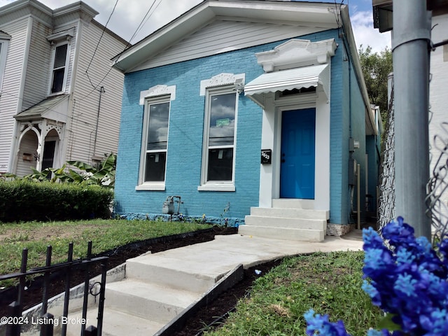 view of exterior entry with a yard