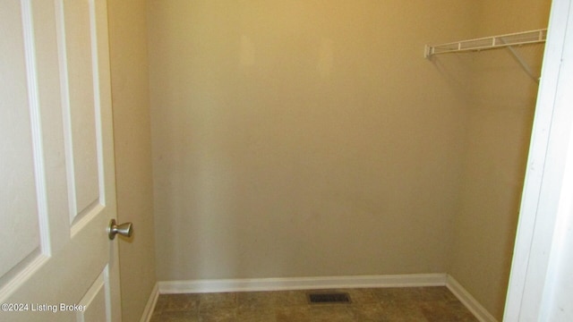 walk in closet with tile flooring