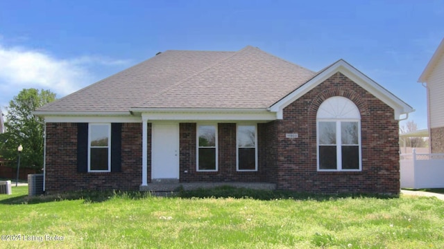 view of front facade with a front yard and central AC unit