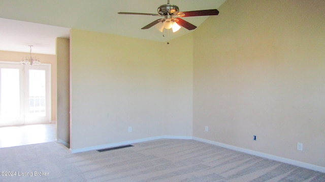 empty room featuring carpet flooring and ceiling fan with notable chandelier