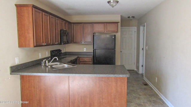 kitchen with black appliances, sink, kitchen peninsula, and dark tile floors