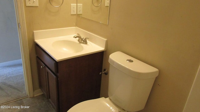 bathroom with tile floors, toilet, and vanity