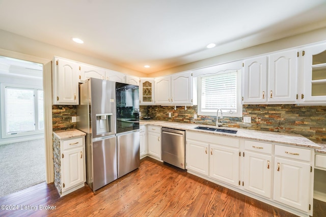 kitchen featuring sink, stainless steel appliances, carpet, and decorative backsplash