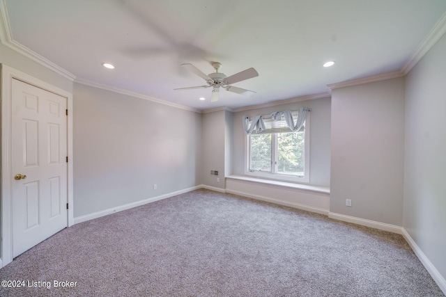 carpeted empty room featuring ceiling fan and ornamental molding