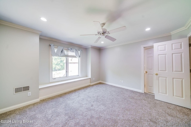 carpeted empty room with ceiling fan and ornamental molding